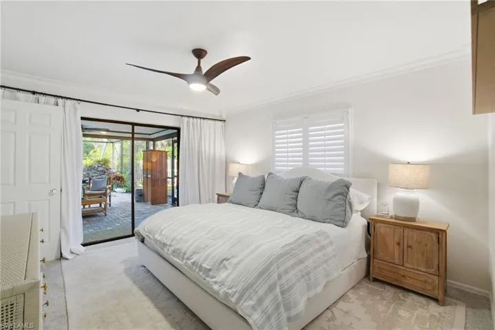 Bedroom featuring crown molding, access to exterior, and a ceiling fan