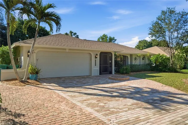 Single story home featuring decorative driveway, stucco siding, an attached garage, and a shingled roof