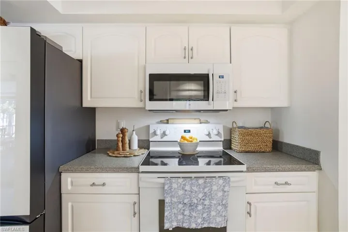 Kitchen with white appliances and white cabinets