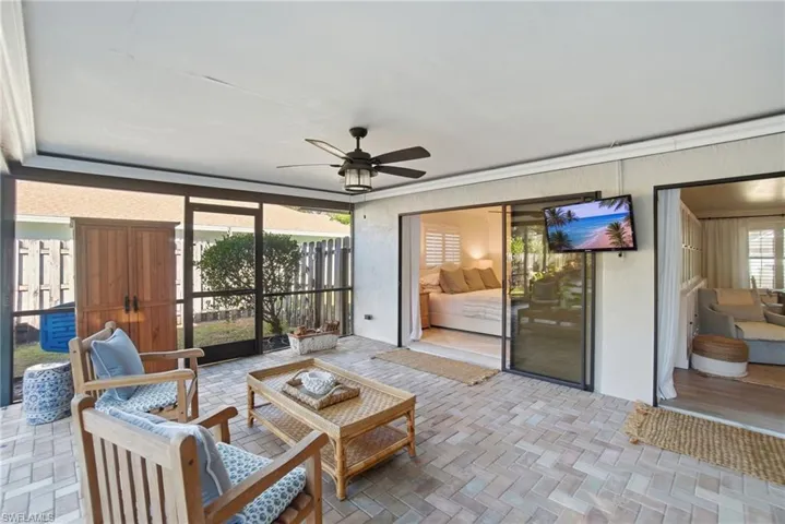 Sunroom featuring ceiling fan, an outdoor hangout area, and a patio