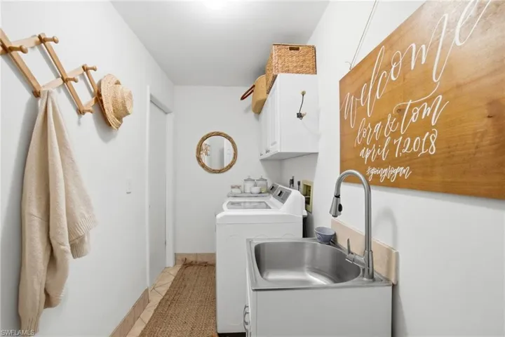 Laundry area with washing machine and clothes dryer and cabinet space