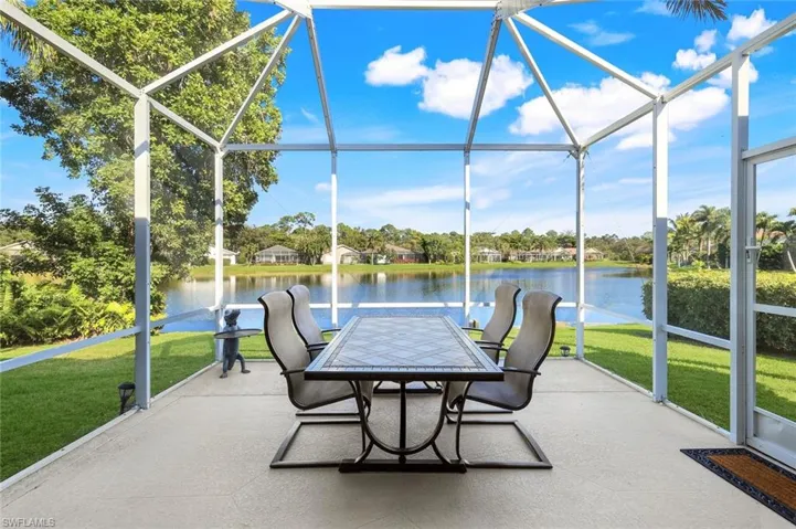 Sunroom / solarium featuring a water view