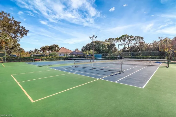 View of tennis court featuring community basketball court and a gazebo