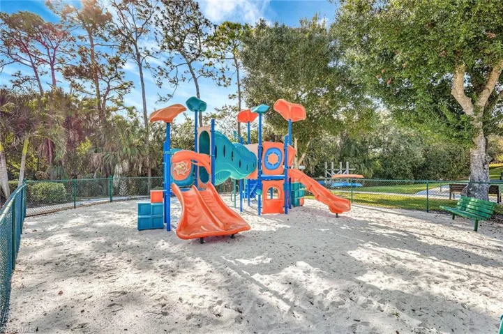Community jungle gym featuring view of wooded area