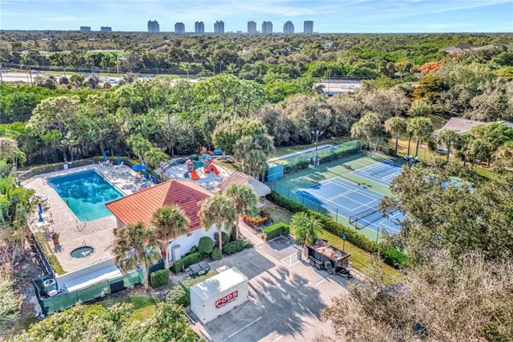 Drone / aerial view of a forest and a pool area