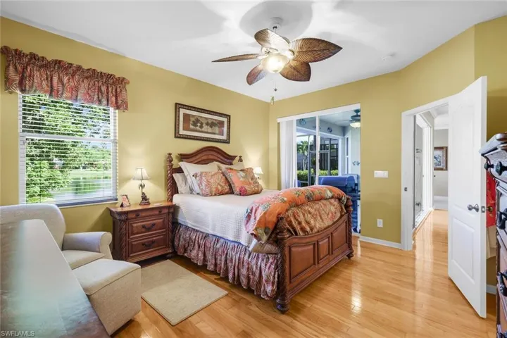 Bedroom featuring light wood-style flooring, access to outside, and a ceiling fan