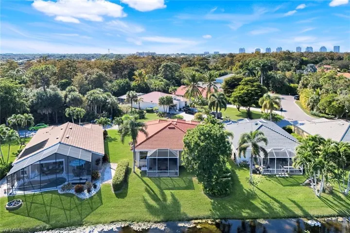 View from above of property featuring city skyline and a tree filled landscape
