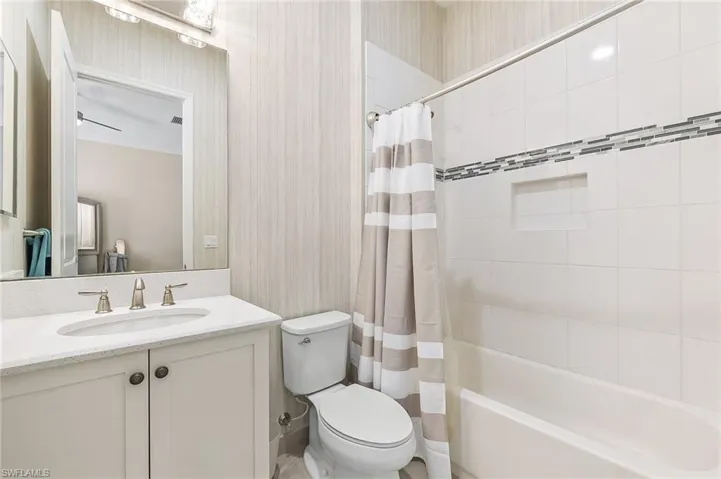 The wallpaper and designer lighting give this bathroom a lift