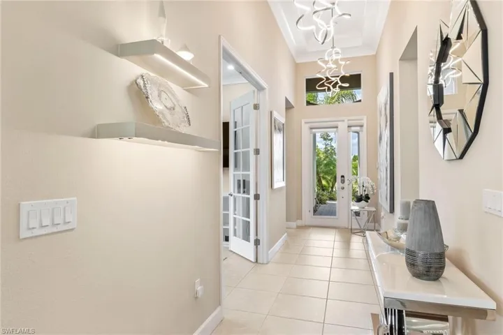 From the moment you step inside you will see custom upgrades throughout.  Glass door, designer lighting, French doors to den...