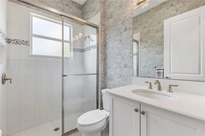 The wallpaper and designer lighting give this bathroom a lift