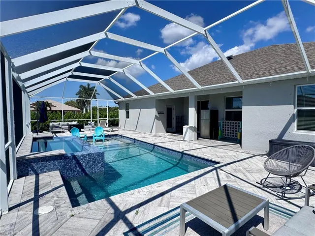 View of swimming pool with a pool with connected hot tub, an outdoor hangout area, a lanai, and a patio