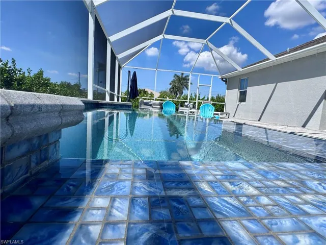 Outdoor pool with a lanai and a patio area
