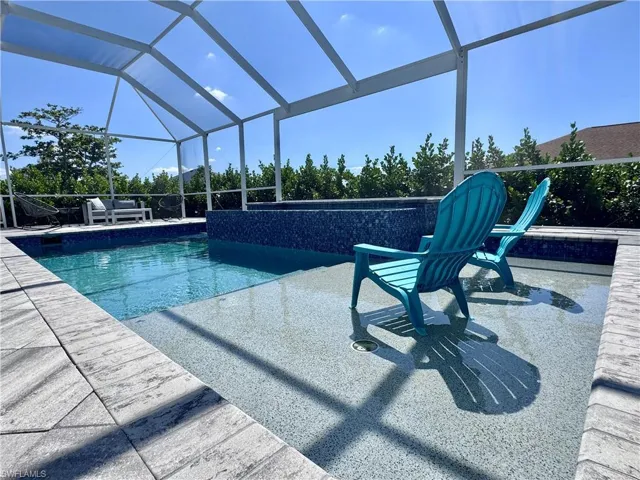 Pool with glass enclosure and a patio