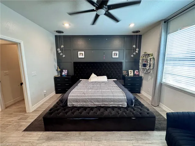 Bedroom with baseboards, wood finished floors, and ceiling fan