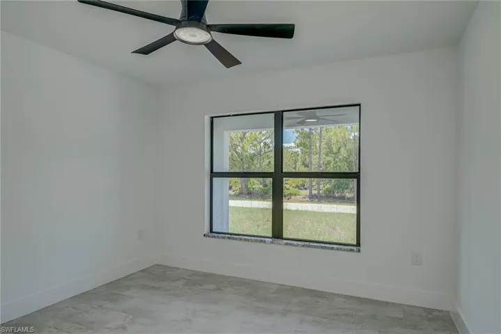 Unfurnished room with baseboards