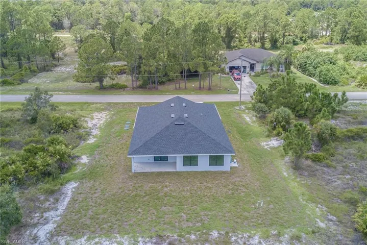 View of subject property featuring a heavily wooded area