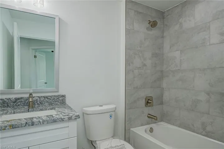 Full bathroom with shower / washtub combination and vanity