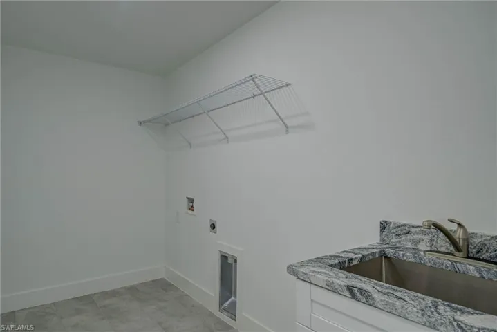 Washroom featuring washer hookup and hookup for an electric dryer