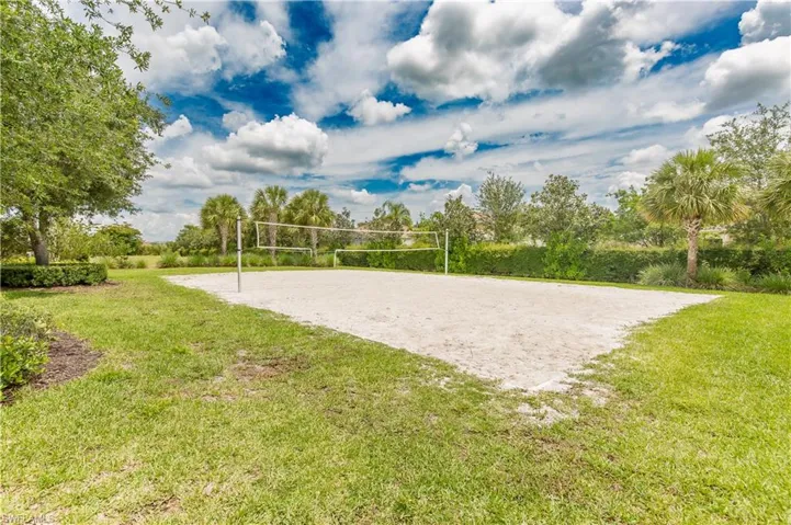 Surrounding community with volleyball court and a yard