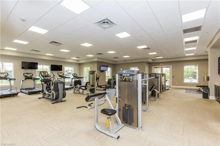 Gym featuring light carpet and a drop ceiling