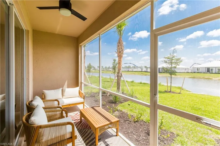 Sunroom featuring a water view and ceiling fan