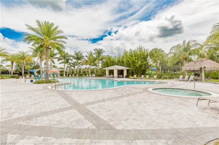 View of pool featuring a hot tub and a patio area