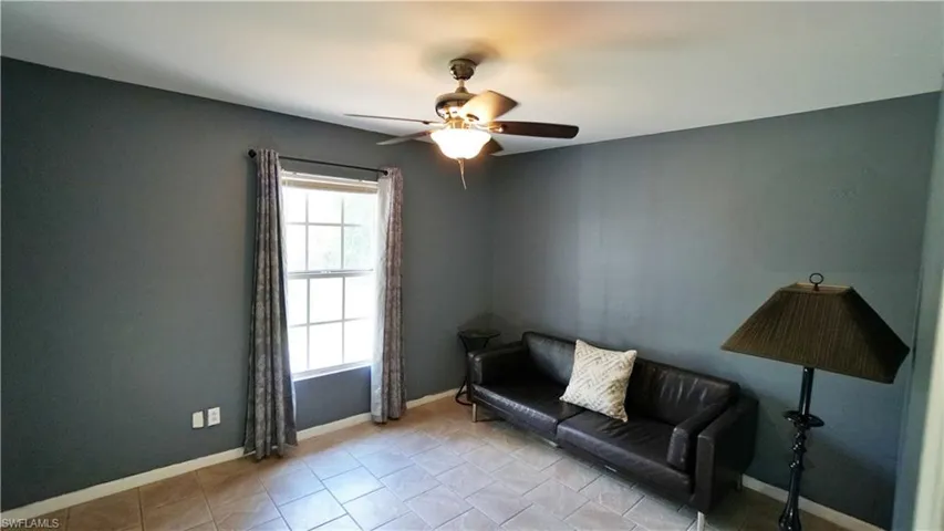 Unfurnished room with tile flooring and ceiling fan