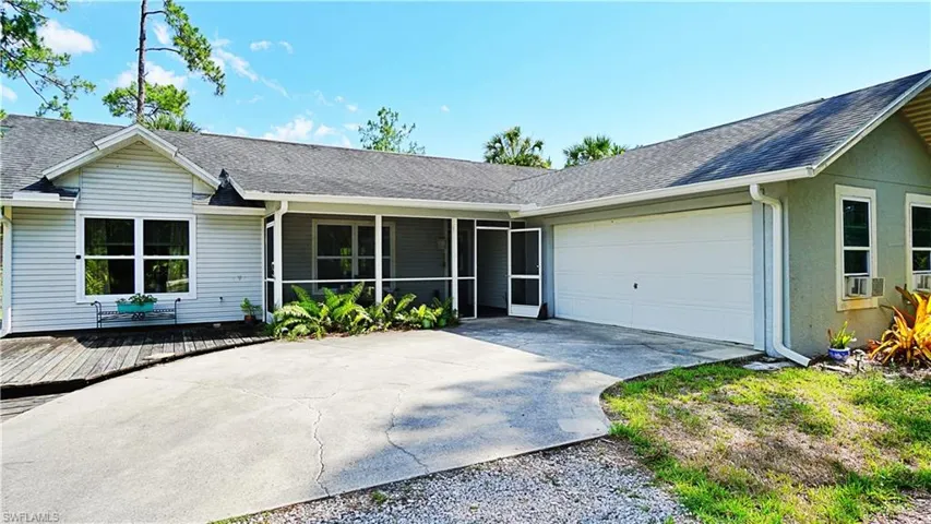Ranch-style home with a sunroom and a garage