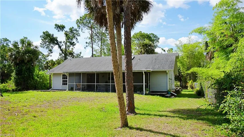 Back of property featuring a yard