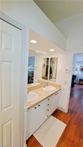 Bathroom with double sink vanity and wood-type flooring