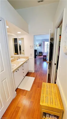 Bathroom with hardwood / wood-style floors, double sink, and large vanity