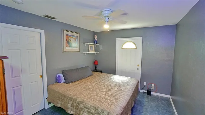 Tiled bedroom with ceiling fan