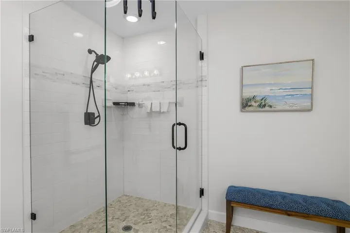 Full bath featuring a shower stall