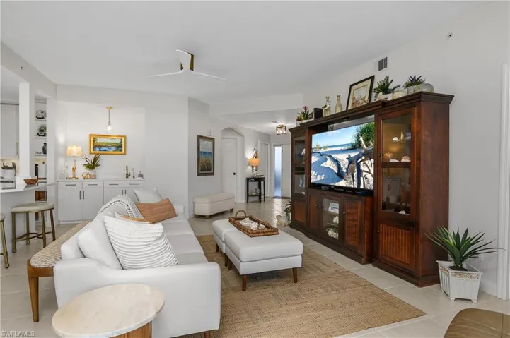 Living area with light tile patterned floors and a ceiling fan