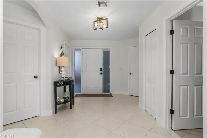 Entryway featuring baseboards and light tile patterned floors
