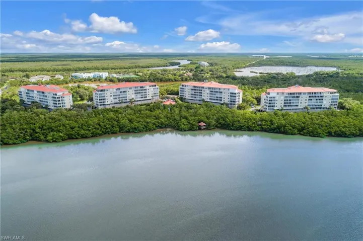 Bird's eye view of apartment complex and a nearby body of water