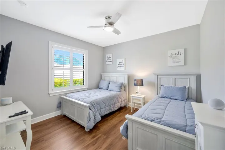 Bedroom featuring hardwood / wood-style flooring and ceiling fan