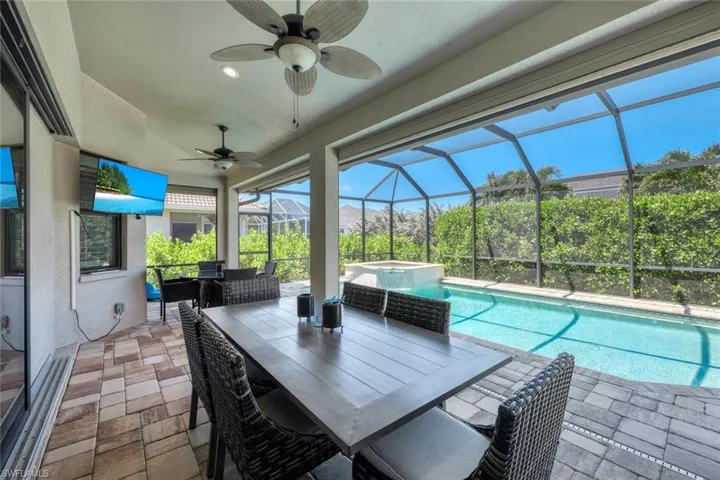 View of pool with a patio, a lanai, an in ground hot tub, and ceiling fan