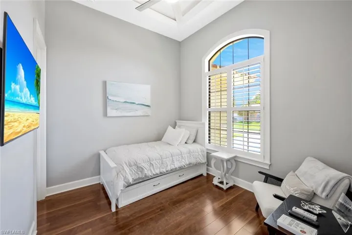 Bedroom featuring ceiling fan and hardwood / wood-style flooring