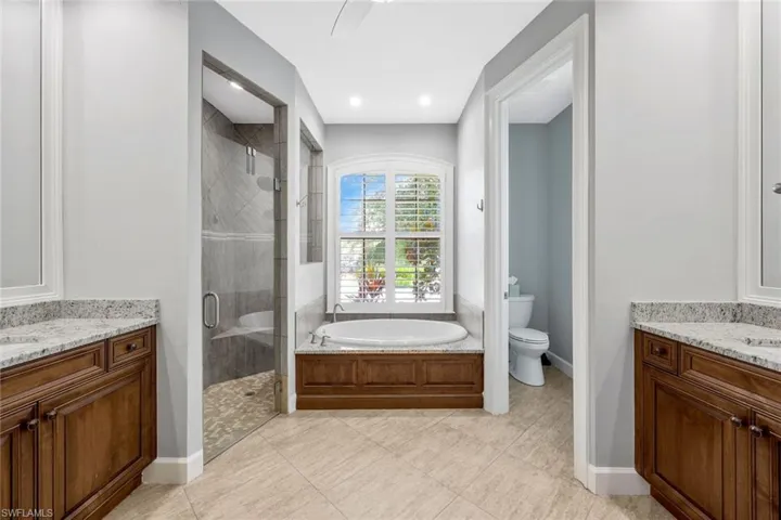 Full bathroom with tile flooring, toilet, and vanity