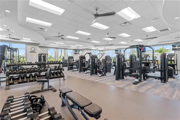 Workout area with ceiling fan and a drop ceiling
