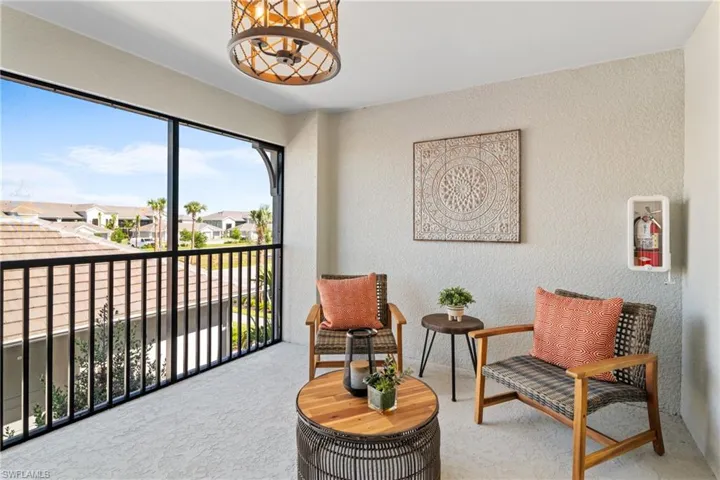 Sitting room featuring a textured wall, carpet flooring, and a residential view