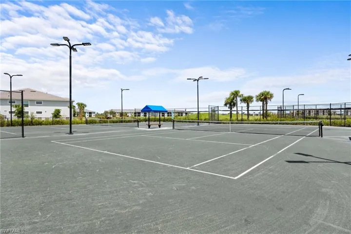 View of tennis court with community basketball court