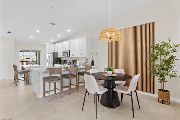 Dining area featuring recessed lighting, lofted ceiling, and light tile patterned floors