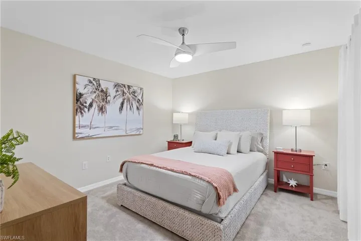 Bedroom with ceiling fan and light colored carpet