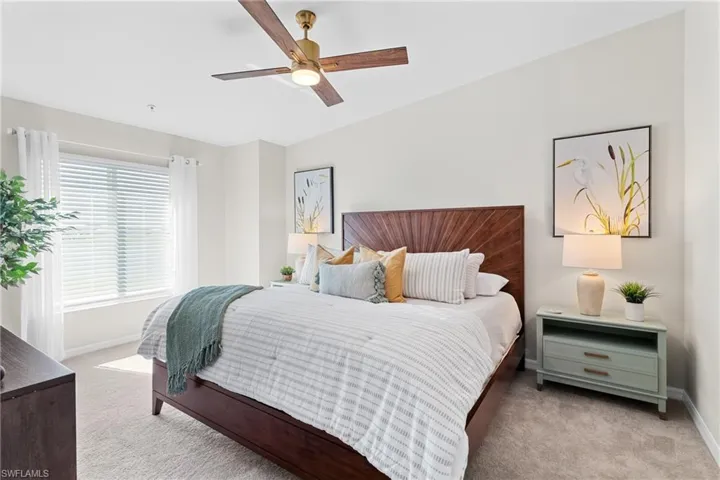 Bedroom featuring light colored carpet and ceiling fan