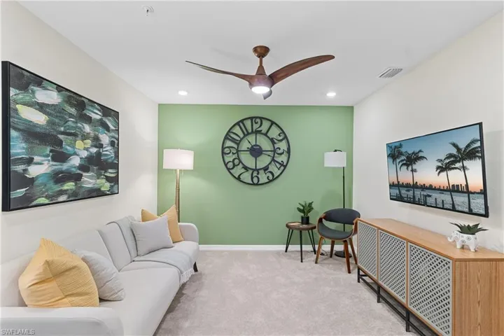 Living room with carpet, ceiling fan, and recessed lighting