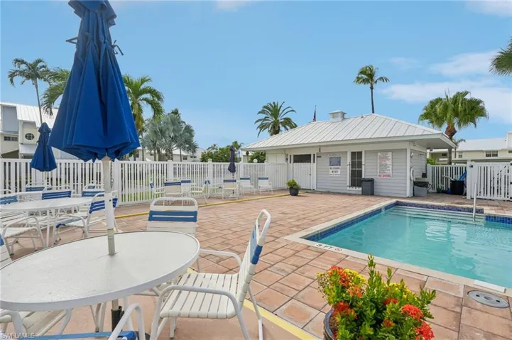 Community pool with a patio and outdoor dining space