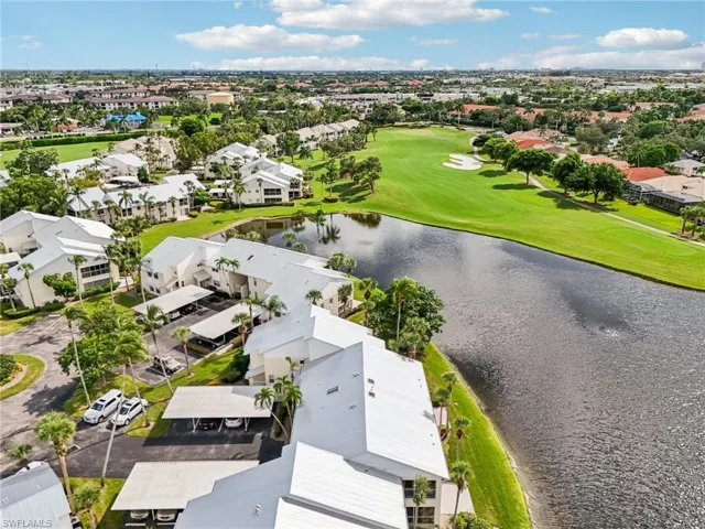 Aerial perspective of suburban area with a large body of water and a local golf course