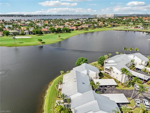 Aerial view of residential area with a large body of water and a golf course